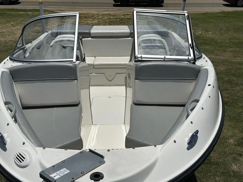 Slide: The Image of 2011 Bayliner 184 SF boat interior with open windshield and seating. - 3