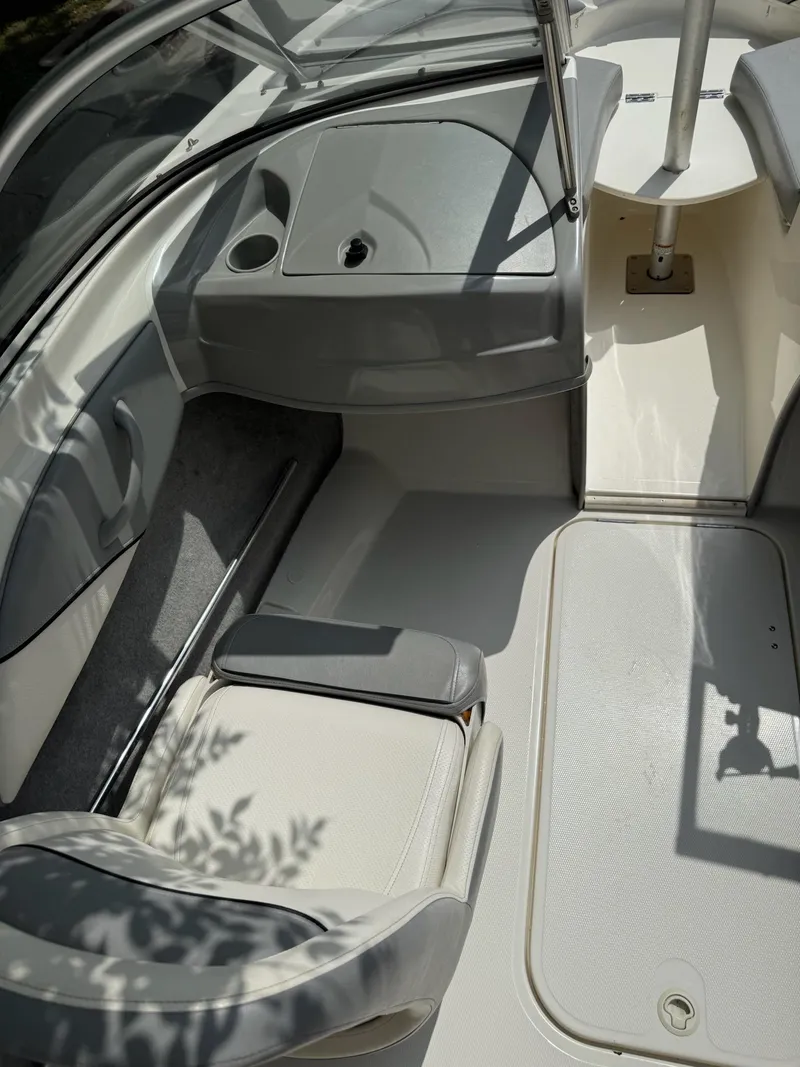 Slide: The Image of 2011 Bayliner 184 SF boat interior with seating and console, featuring a sleek design. - 4