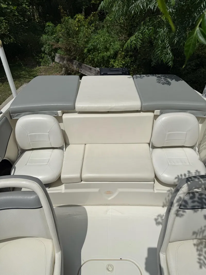 Slide: The Image of 2011 Bayliner 184 SF boat interior with white seating and gray cushions. - 5