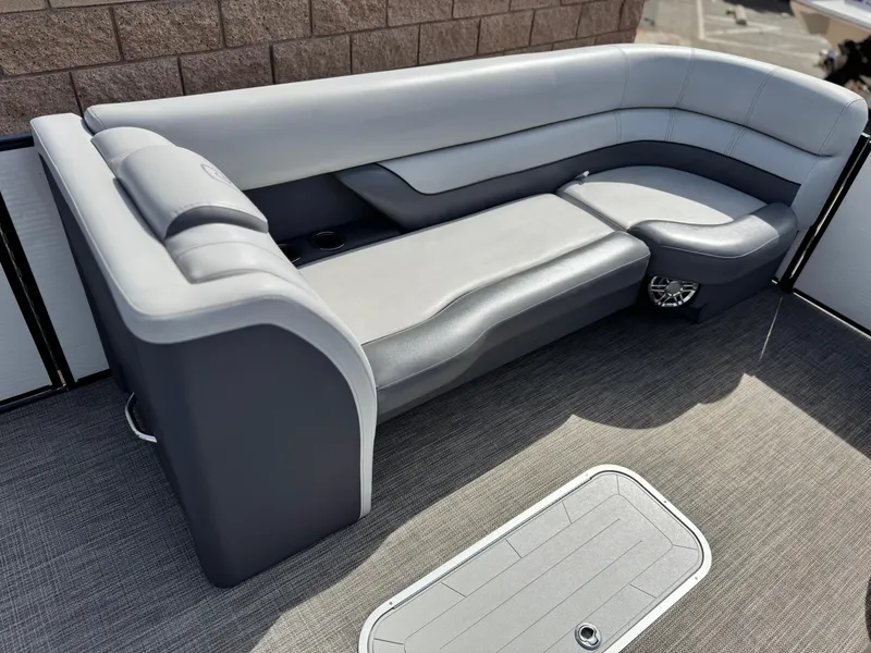 Slide: The Image of 2023 Godfrey Monaco 255 C boat interior with gray seating and carpeted floor. - 10