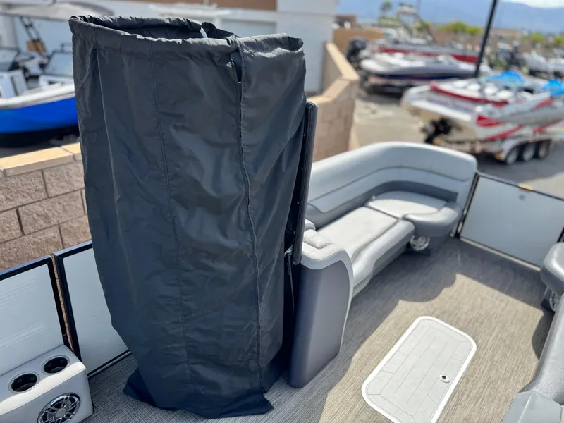 Slide: The Image of 2023 Godfrey Monaco 255 C pontoon boat interior with seating and covered area. - 12