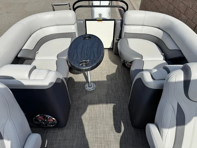 Slide: The Image of 2023 Godfrey Monaco 255 C boat interior with plush seating and sleek table design. - 18