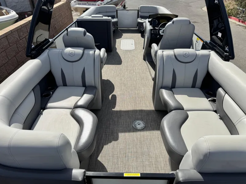 Slide: The Image of 2023 Godfrey Monaco 255 C pontoon boat with spacious seating and modern interior design. - 23