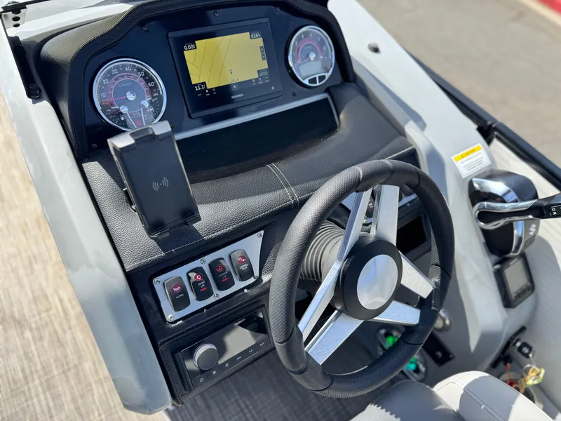 Slide: The Image of Steering console of 2023 Godfrey Monaco 255 C boat with modern controls and display. - 26