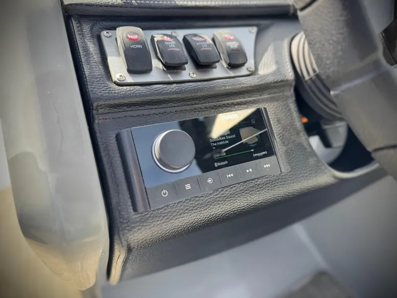 Slide: The Image of Control panel of 2023 Godfrey Monaco 255 C boat with audio system and switches. - 29