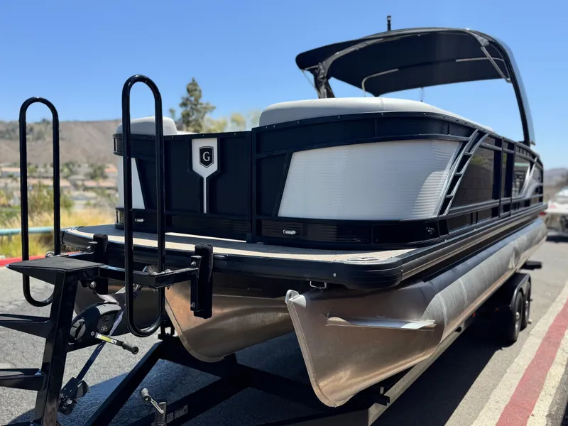 Slide: The Image of 2023 Godfrey Monaco 255 C pontoon boat on trailer, sunny day, outdoor setting. - 3