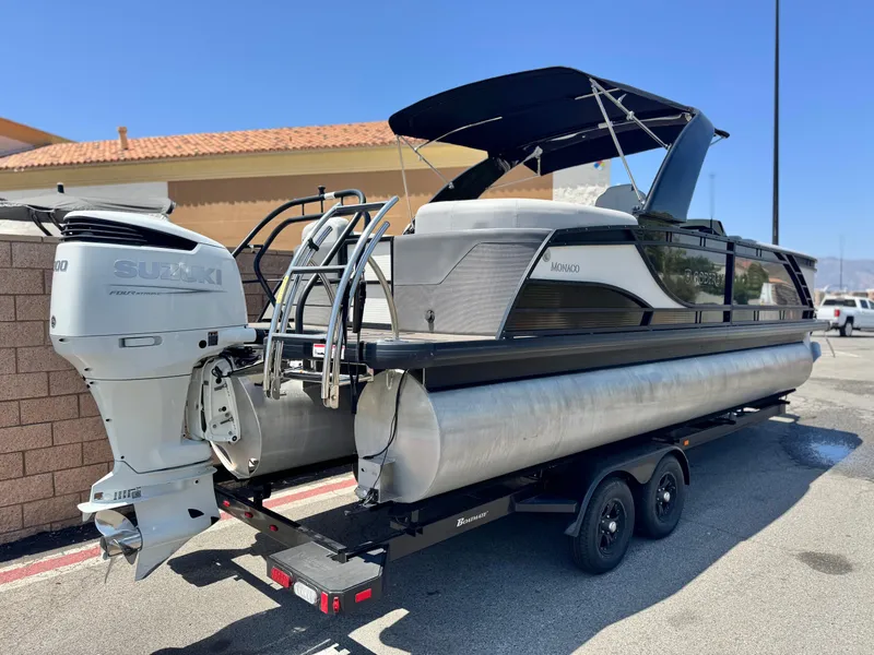 Slide: The Image of 2023 Godfrey Monaco 255 C pontoon boat with Suzuki outboard motor on trailer. - 6
