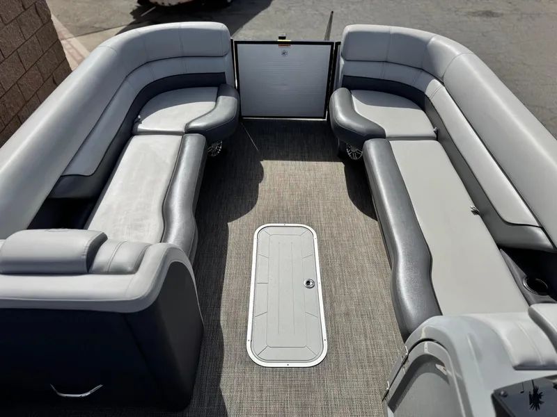 Slide: The Image of 2023 Godfrey Monaco 255 C pontoon boat interior with gray seating and carpeted floor. - 9