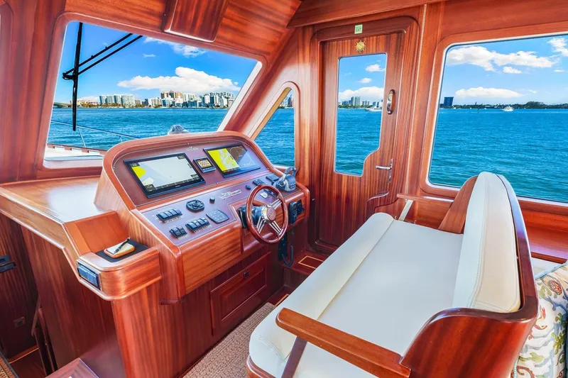 Slide: The Image of 2024 Vicem 62 Classic yacht interior with wooden helm and ocean view. - 14