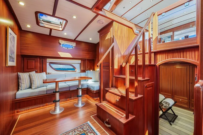 Slide: The Image of Luxurious interior of 2024 Vicem 62 Classic yacht with elegant wood finish and cozy seating area. - 16