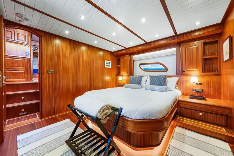 Slide: The Image of Luxurious 2024 Vicem 62 Classic yacht cabin with elegant wood paneling and cozy bedding. - 21
