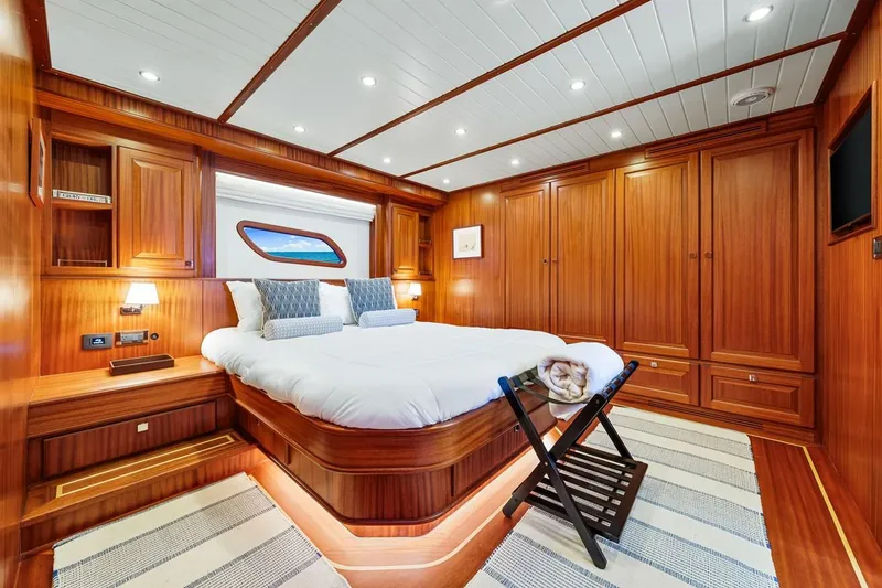 Slide: The Image of Luxurious 2024 Vicem 62 Classic yacht cabin with elegant wood paneling and cozy bedding. - 22