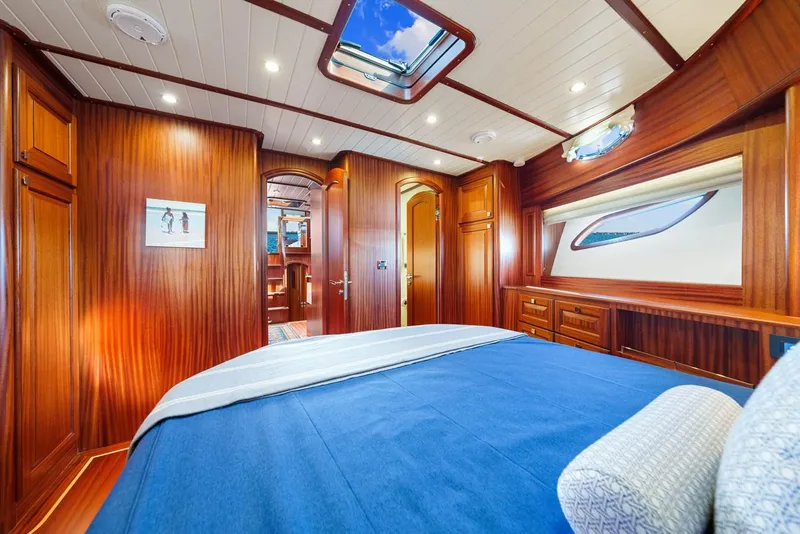 Slide: The Image of Luxurious interior of 2024 Vicem 62 Classic yacht with elegant wood paneling and skylight. - 28