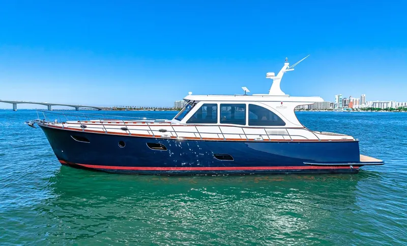 Slide: The Image of 2024 Vicem 62 Classic yacht on clear blue water, bridge and cityscape in background. - 35