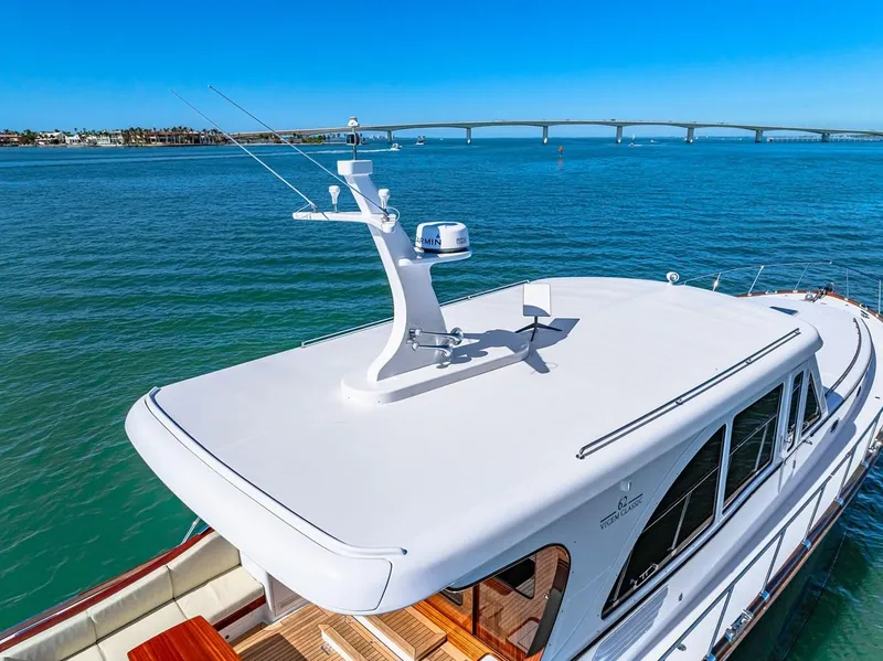 Slide: The Image of 2024 Vicem 62 Classic yacht on serene water with bridge in background. - 5