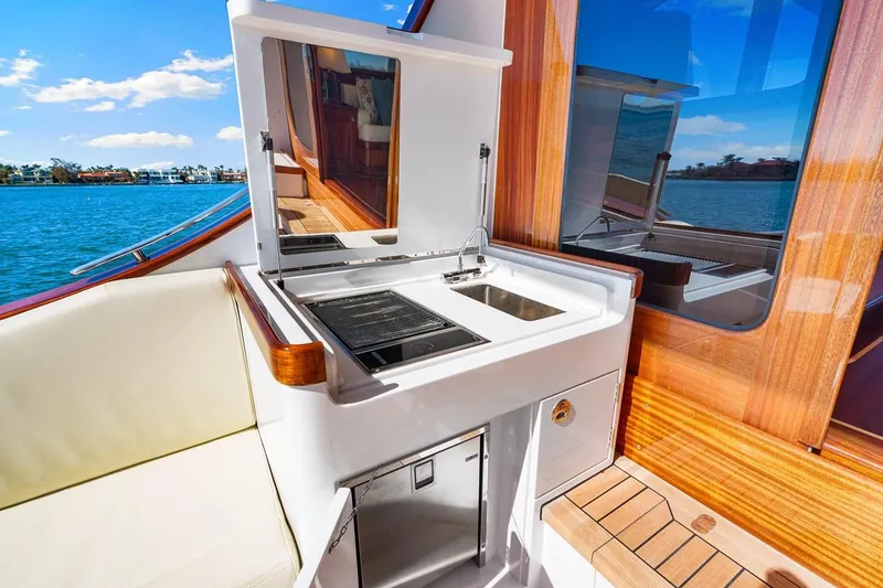 Slide: The Image of 2024 Vicem 62 Classic yacht with outdoor kitchenette and scenic water view. - 9