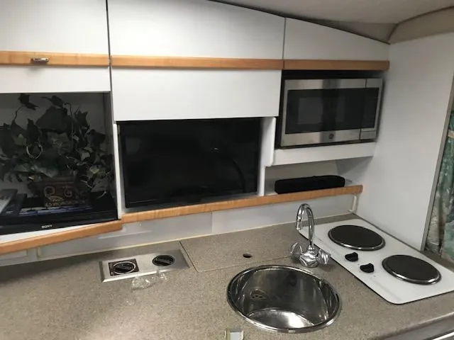 Slide: The Image of 1998 Formula 31 PC yacht kitchen with sink, stove, and microwave. - 10