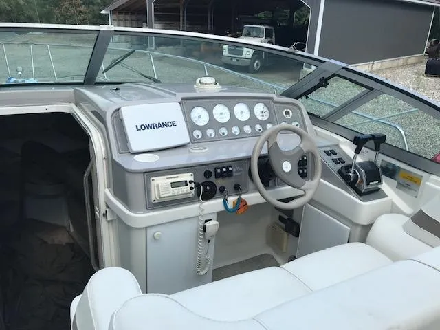 Slide: The Image of 1998 Formula 31 PC boat cockpit with steering wheel, gauges, and Lowrance navigation system. - 5