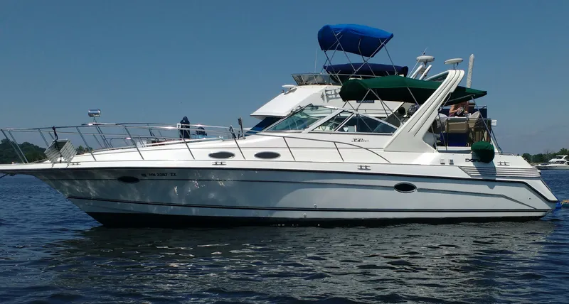 The Image of 1996 Doral 350SC boat on water, featuring sleek design and multiple decks under clear blue sky. - 0