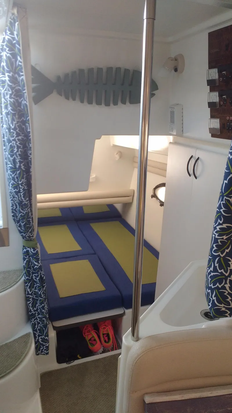 Slide: The Image of Interior of 1996 Doral 350SC boat with cozy cabin and decorative elements. - 13