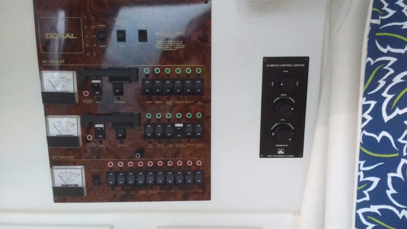 Slide: The Image of Electrical control panel on a 1996 Doral 350SC boat, featuring various switches and meters. - 14