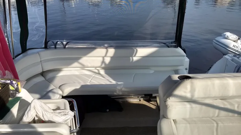 Slide: The Image of Interior of a 1996 Doral 350SC boat with white seating and water view. - 17