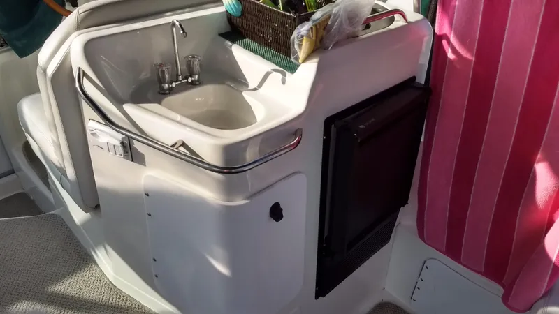 Slide: The Image of 1996 Doral 350SC boat interior with sink and storage area. - 18