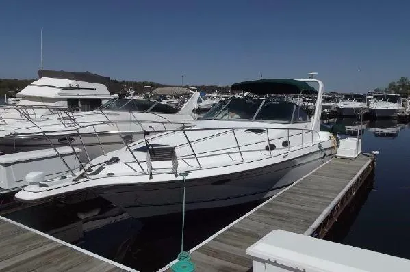 Slide: The Image of 1996 Doral 350SC boat docked at marina under clear blue sky. - 2