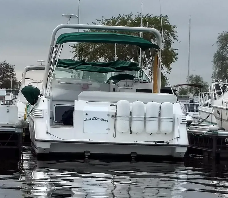 Slide: The Image of 1996 Doral 350SC boat docked, featuring green canopy and white fenders. - 5