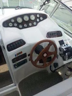 Slide: The Image of 1996 Doral 350SC boat dashboard with gauges and wooden steering wheel. - 6