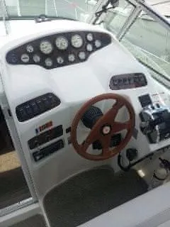 Slide: The Image of 1996 Doral 350SC boat dashboard with steering wheel and instrument panel. - 8