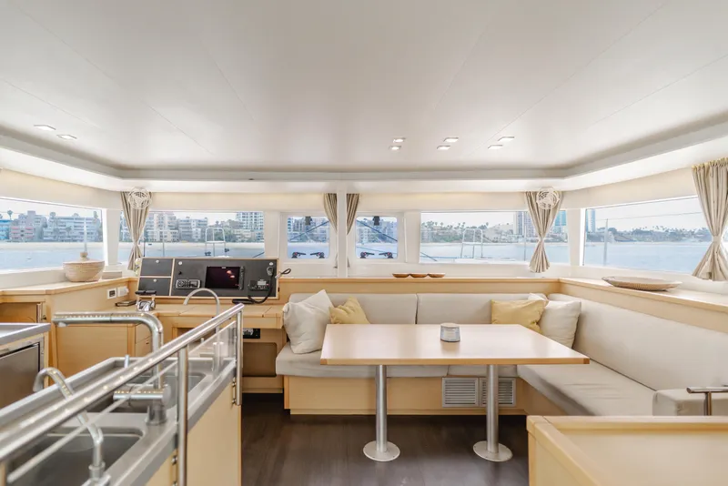 Slide: The Image of Interior of 2016 Lagoon 450F catamaran with spacious seating and panoramic windows. - 2