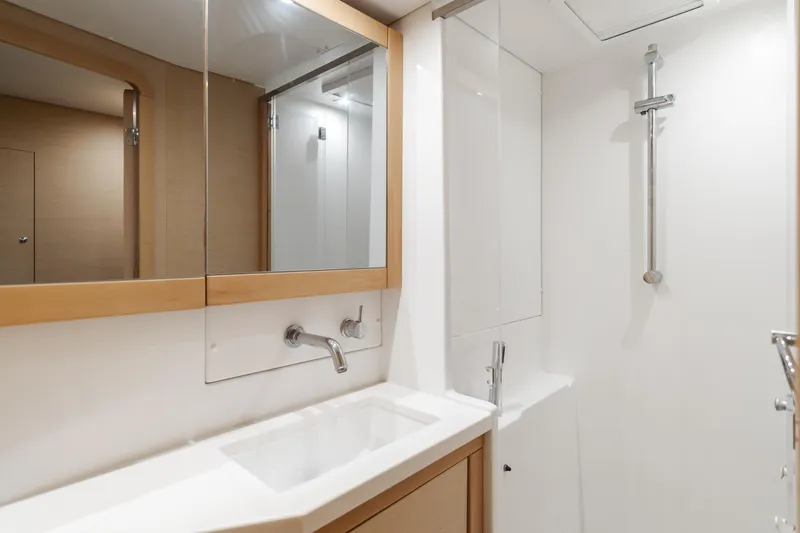 Slide: The Image of Modern bathroom interior in a 2016 Lagoon 450F yacht, featuring sleek fixtures and a minimalist design. - 25