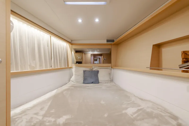 Slide: The Image of Cozy cabin interior of 2016 Lagoon 450F catamaran with plush bedding and soft lighting. - 26