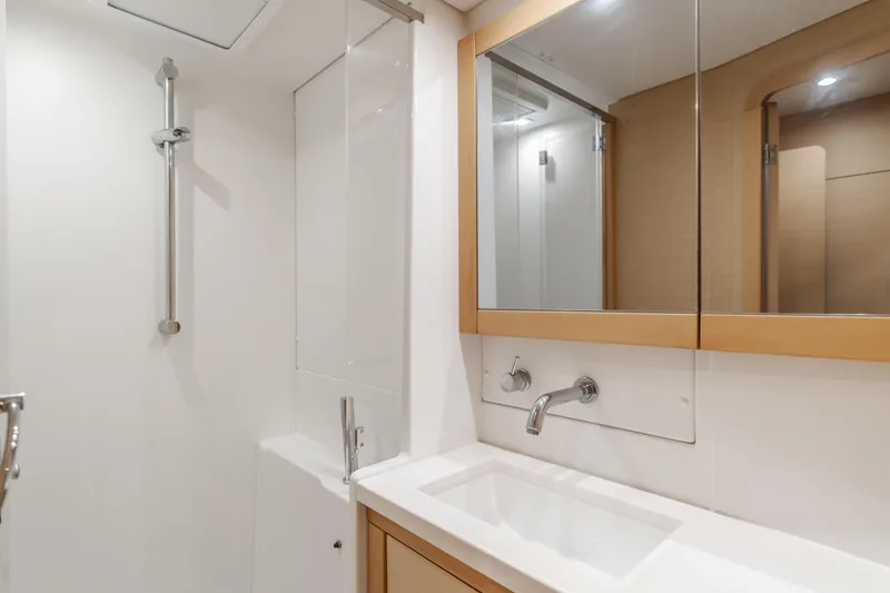 Slide: The Image of Modern bathroom in 2016 Lagoon 450F yacht with sleek fixtures and mirrored cabinet. - 28