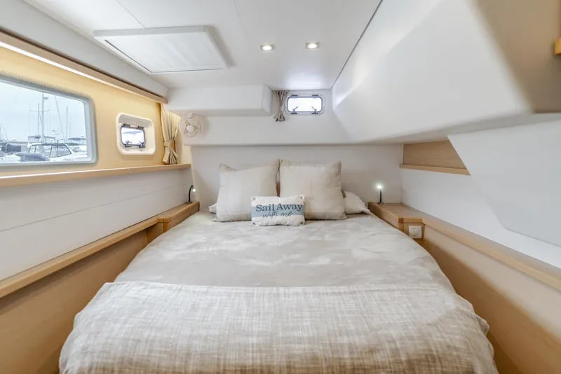Slide: The Image of Luxurious cabin interior of a 2016 Lagoon 450F catamaran with cozy bedding and natural light. - 30