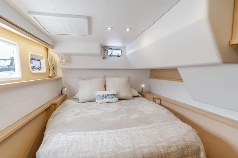 Slide: The Image of Luxurious cabin interior of 2016 Lagoon 450F catamaran with cozy bed and natural light. - 31