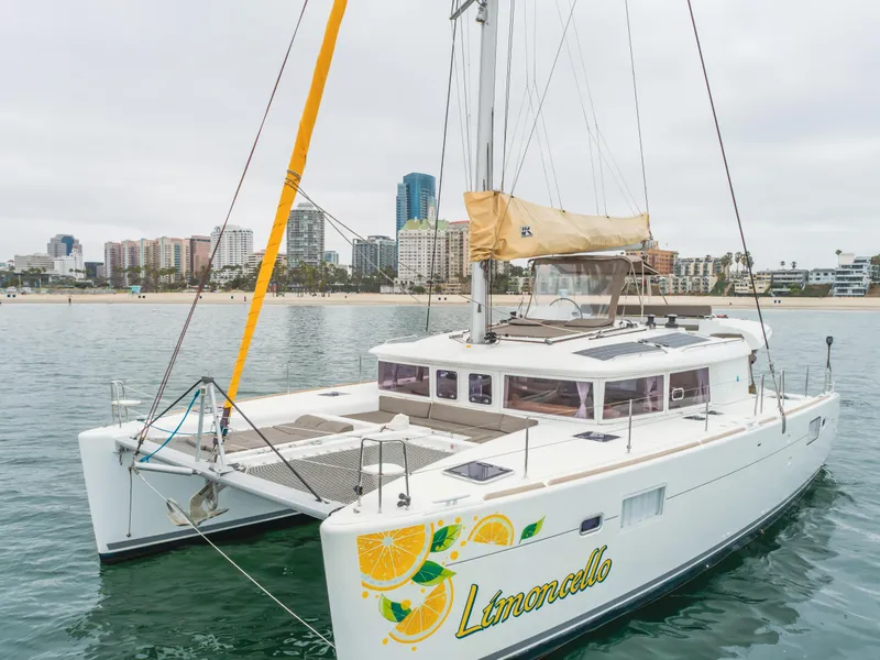 Slide: The Image of 2016 Lagoon 450F catamaran "Limoncello" on water near city skyline. - 4