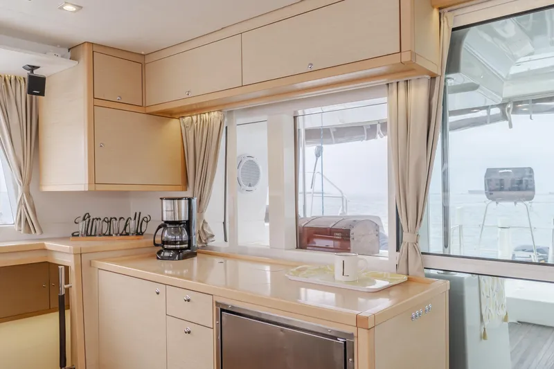 Slide: The Image of Modern kitchen interior on 2016 Lagoon 450F yacht with light wood cabinetry. - 41