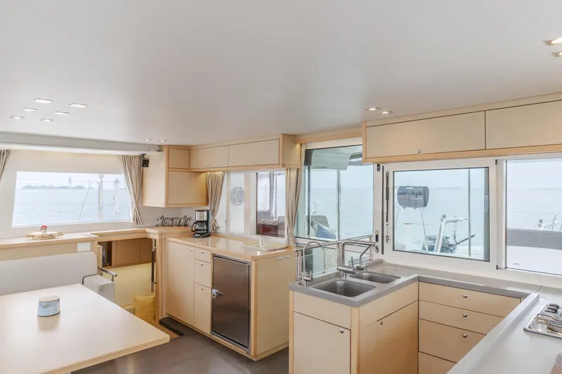 Slide: The Image of Spacious interior of 2016 Lagoon 450F catamaran with modern kitchen and large windows. - 42