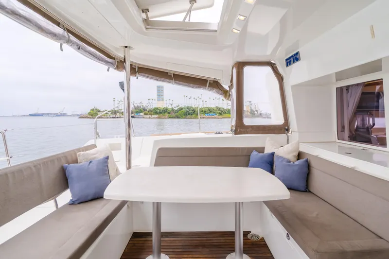 Slide: The Image of Interior of 2016 Lagoon 450F catamaran with seating area and ocean view. - 44
