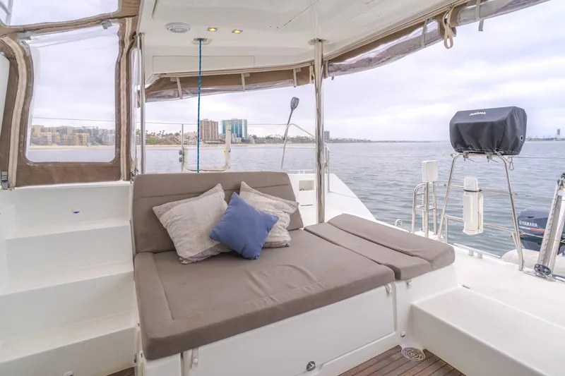 Slide: The Image of 2016 Lagoon 450F yacht deck with cushioned seating and scenic water view. - 45