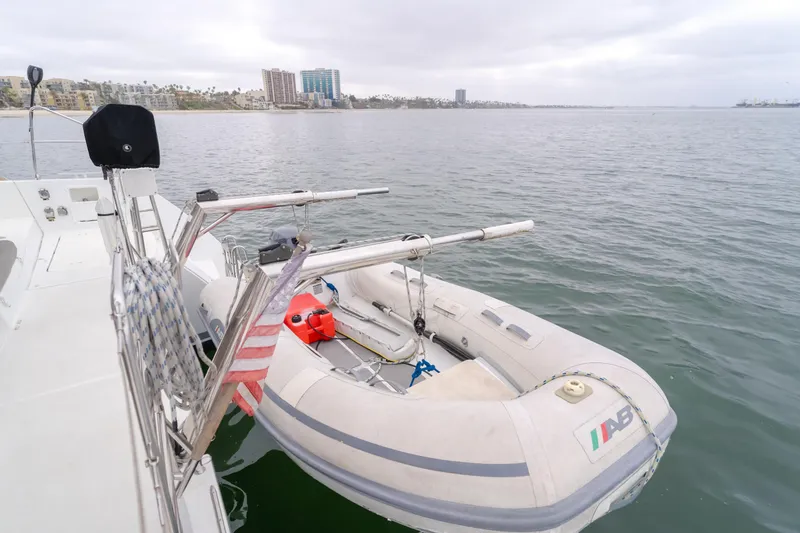 Slide: The Image of Lagoon 450F 2016 yacht with attached inflatable dinghy on calm waters. - 47