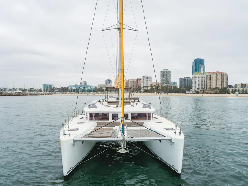 Slide: The Image of 2016 Lagoon 450F catamaran on water with city skyline in background. - 7