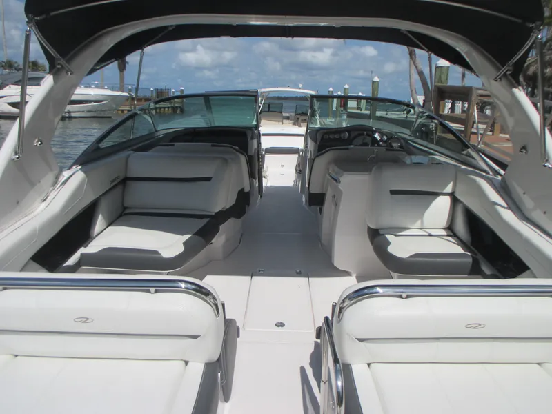 Slide: The Image of 2017 Regal 3200 Bowrider interior with spacious seating and sleek design at a marina. - 10
