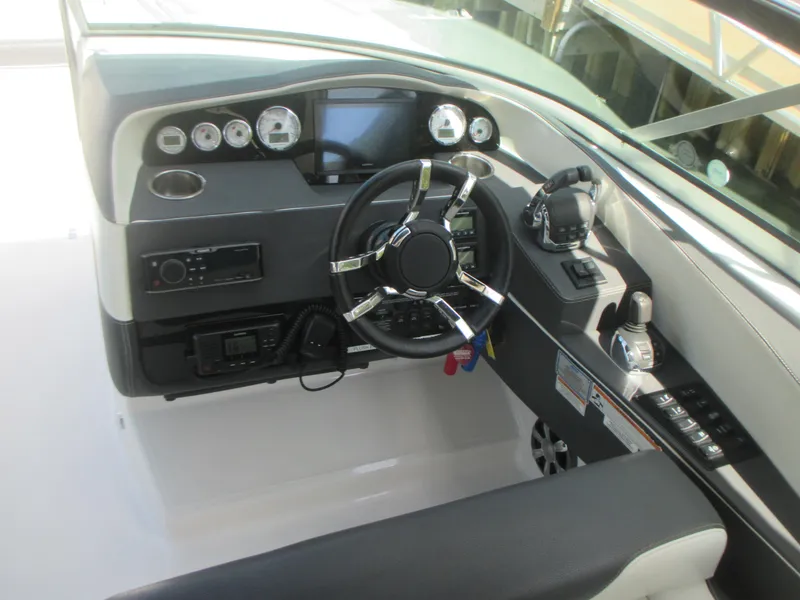 Slide: The Image of 2017 Regal 3200 Bowrider dashboard with steering wheel and control panel. - 13