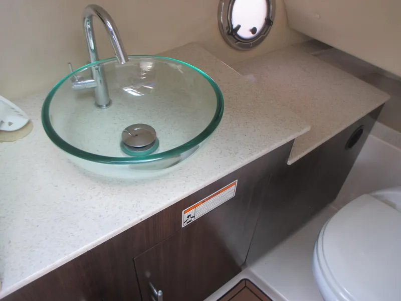 Slide: The Image of Luxurious bathroom in 2017 Regal 3200 Bowrider with glass sink and modern fixtures. - 17