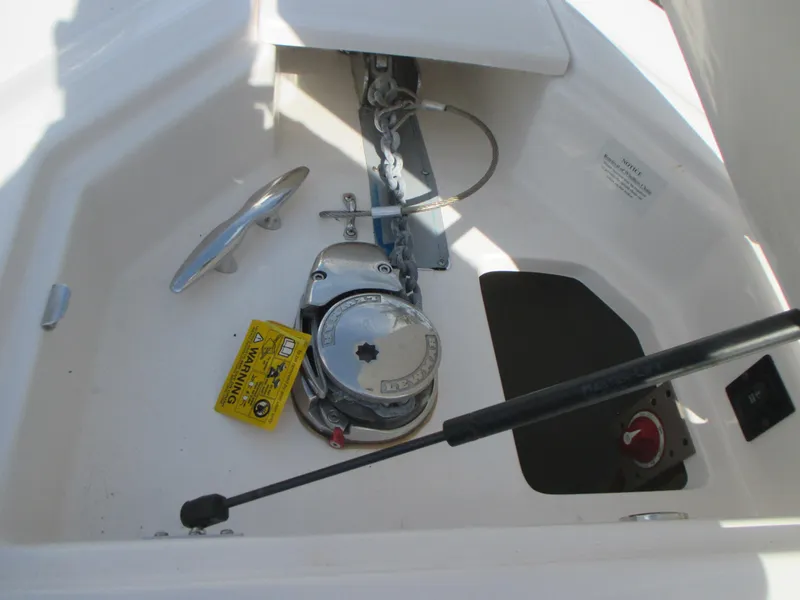 Slide: The Image of 2017 Regal 3200 Bowrider anchor compartment with winch and cleat. - 20
