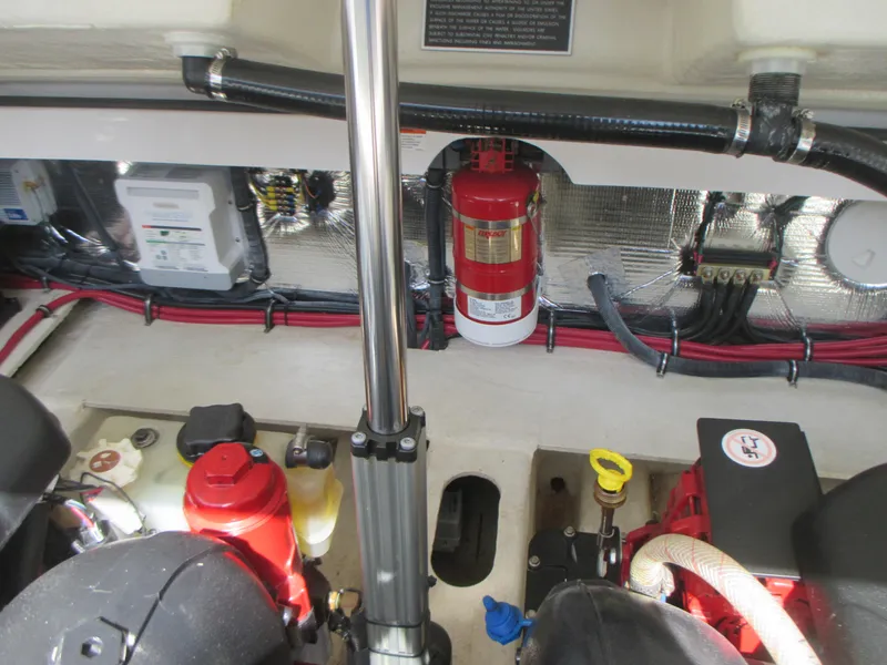 Slide: The Image of Engine compartment of 2017 Regal 3200 Bowrider with fire extinguisher and wiring. - 24