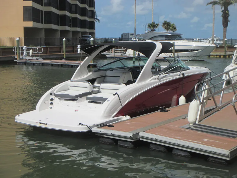 Slide: The Image of 2017 Regal 3200 Bowrider docked at marina, featuring sleek design and spacious seating. - 4